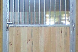 stock-photo-stable-barn-with-beam-ceiling-and-open-door-to-a-clean-stall-179350517